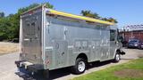 A 2005 Morgan Olson Workhorse vehicle with a metallic body features multiple access panels and a yellow awning on the roof