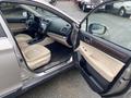 A 2019 Subaru Outback with an open driver door showcasing beige leather seats and a modern dashboard with a touchscreen display