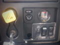 Dashboard controls of a 2008 International 7400 featuring buttons for various functions and a filter indicator gauge