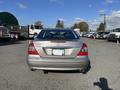 A 2007 Mercedes-Benz E-Class E350 parked with a silver exterior and dual exhaust pipes visible at the rear