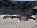 A rusted exhaust pipe and catalytic converter under a 2013 International 4300 truck