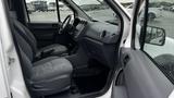 Interior of a 2012 Ford Transit showing front seats and dashboard with a simple gray design and a steering wheel