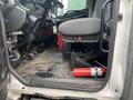 Interior of a 2018 Hino 308 truck showing the driver's seat steering wheel and a fire extinguisher on the floor