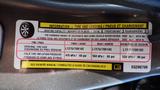 A 2014 RAM 3500 tire information label with details on tire size cold tire pressure and load capacity