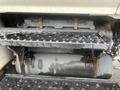 A close-up of the engine compartment of a 2008 Hino 268 showing the engine assembly and various mechanical components with visible wear and dirt
