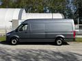 A 2021 Mercedes-Benz Sprinter van in gray parked on a concrete surface with a streamlined shape and large cargo area