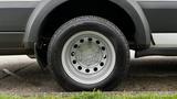 A close-up of a silver wheel with a black tire featuring a tread pattern typical of a 2017 Ford Transit