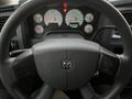 A 2008 Dodge Ram 5500 steering wheel with the Dodge logo visible and various dashboard gauges lit up in the background