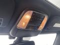 Interior overhead console of a 2018 Jeep Grand Cherokee featuring lights and control buttons