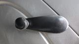 A black door handle lever for a 2010 International 4300 with a round knob at the end and a sleek, curved design