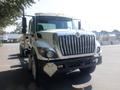 A 2009 International 7400 truck with a large chrome grille and prominent headlights facing forward