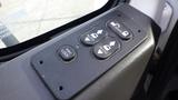 Control panel with buttons for win lock door and auto functions on a 2012 International TerraStar vehicle