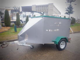 A 2016 Parksville generator on a small trailer with a metallic body and a green trim