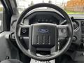 Steering wheel of a 2011 Ford F-250 SD with the Ford logo and dashboard controls visible