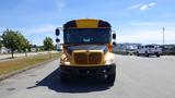 A yellow and black 2014 International 3000 school bus facing directly towards the camera with its headlights on and windshield visible