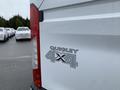 A 2017 Ford Transit van featuring a Quigley 4x4 badge on the rear panel