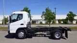 A white 2015 Mitsubishi Fuso FE truck in profile view with a chassis visible and no cargo bed attached