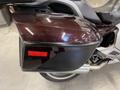 A close-up view of the rear storage compartment of a 2013 BMW K1600GTL motorcycle featuring a maroon and black color scheme