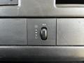 Control panel of a 2015 Chevrolet Express featuring a fan speed dial and an AUX input selector