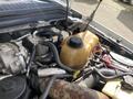 Engine compartment of a 2010 Ford F-550 showing various mechanical components including hoses radiator and coolant reservoir