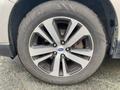 A close-up of a 2019 Subaru Outback wheel featuring a multi-spoke alloy rim and a Cooper tire