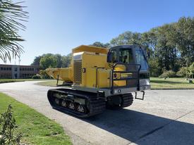 A yellow and gray TerraMac RT7R tracked machine with a wide tracks and a large hopper at the rear designed for construction and heavy-duty work