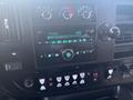 Dashboard of a 2017 Chevrolet Express featuring knobs and buttons for climate control audio settings and various functions