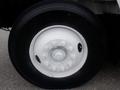 Close-up of a tire on a 2009 International 7400 featuring a white rim with multiple bolts and a black treaded tire with visible branding