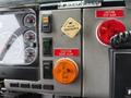 Dashboard of a 2001 Freightliner FL80 showing gauges switches and warning lights including caution door ajar and caution step ajar indicators