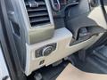 Interior view of a 2019 Ford F-350 SD with controls on the dashboard and steering column visible along with the gear shift and floor mat