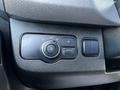 Close-up of a control panel in a 2022 Mercedes-Benz Sprinter featuring a dial for headlights and several buttons for vehicle settings