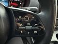 Close-up of a control panel on the steering wheel of a 2019 Mercedes-Benz Sprinter featuring buttons for volume navigation and phone functions