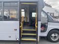 A 2017 Chevrolet Express bus with an open door and yellow steps leading inside