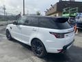 A white 2020 Land Rover Range Rover Sport with a sleek design and black accents parked at a service location