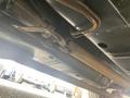 Underside view of a 1966 Ford Mustang showing the exhaust system and some mechanical components