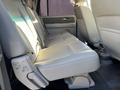 The image shows the rear interior seating of a 2013 Ford Expedition with light gray leather upholstery and a spacious bench seat