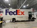 A 2010 Freightliner MT45 delivery truck with the FedEx logo prominently displayed on the side in blue and red colors