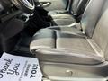 A black leather seat in the driver's area of a 2019 Mercedes-Benz Sprinter with a partially visible floor mat that says Thank You
