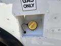 A fuel cap with a yellow handle is visible inside a fuel access door labeled GAS ONLY on a 2012 Ford Econoline