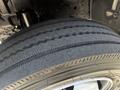 A close-up of a tire from a 2020 Hino 195 showing deep treads and a metallic rim