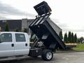 A 2015 Ford F-550 dump truck with an elevated bed showing a large cargo area designed for transporting materials