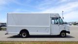 A white 2011 Ford Econoline van with a boxy shape and large cargo space visible from the side