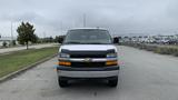 A 2017 Chevrolet Express Quigley 4x4 van with a white exterior and black accents facing directly towards the camera