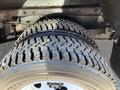 Close-up of a Bridgestone tire on a 2012 Ford Econoline showcasing the tread pattern and metal rim