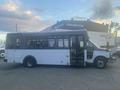 A white 2017 Chevrolet Express bus with large windows and accessible side entrance