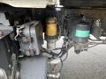 Close-up of the engine compartment of a 2008 Hino 268 highlighting the fuel filter and various mechanical components connected by hoses and wires