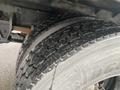 Close-up of a tire from a 2018 Hino 308 showing a tread pattern with visible wear and debris on the surface of the tire