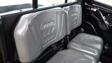 Gray bench seats of a 2018 Kubota RTV X1100c with molded designs and armrest space between them