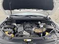 A 2018 Jeep Grand Cherokee engine compartment displaying the engine and various components including the air intake and battery