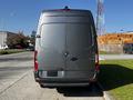 A gray 2021 Mercedes-Benz Sprinter van viewed from the rear with a simple design and prominent logo